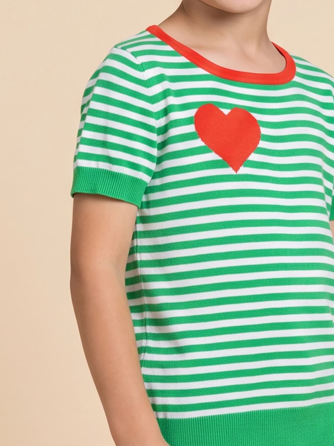 Close view of the knit, stripe, neckline and red heart detail