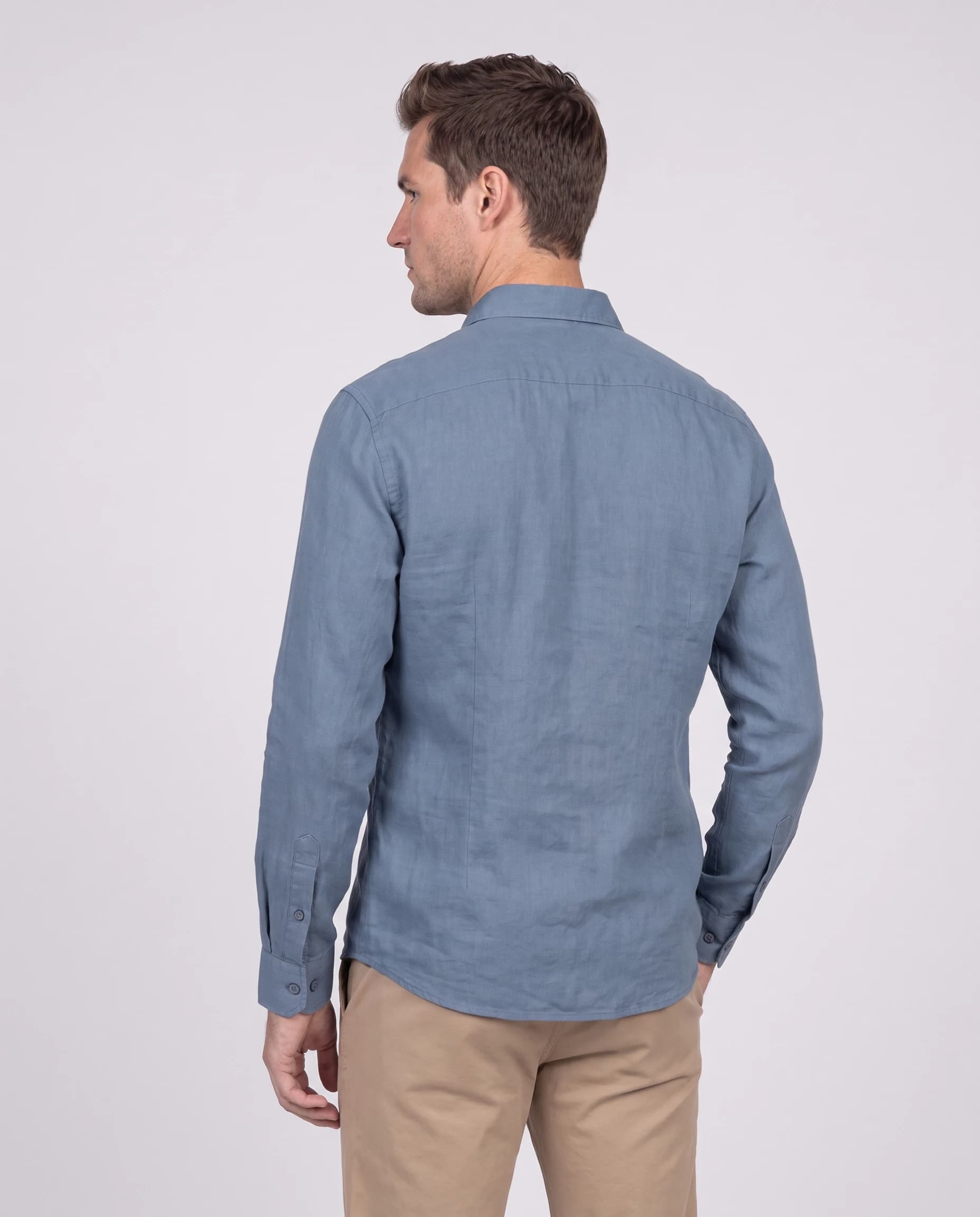 Back menswear catalogue view wearing a blue shirt and khaki trousers