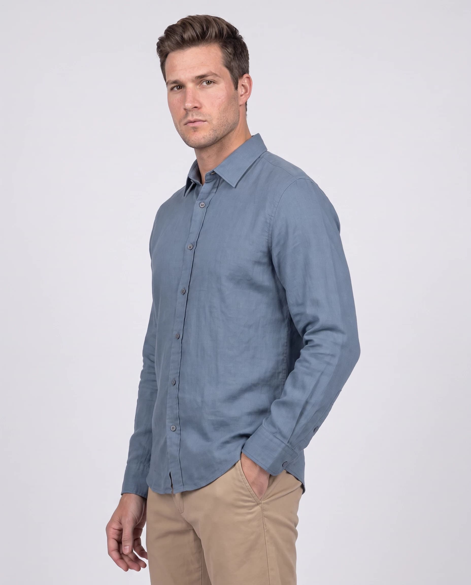 Three-quarter menswear catalogue view wearing a blue shirt and khaki trousers